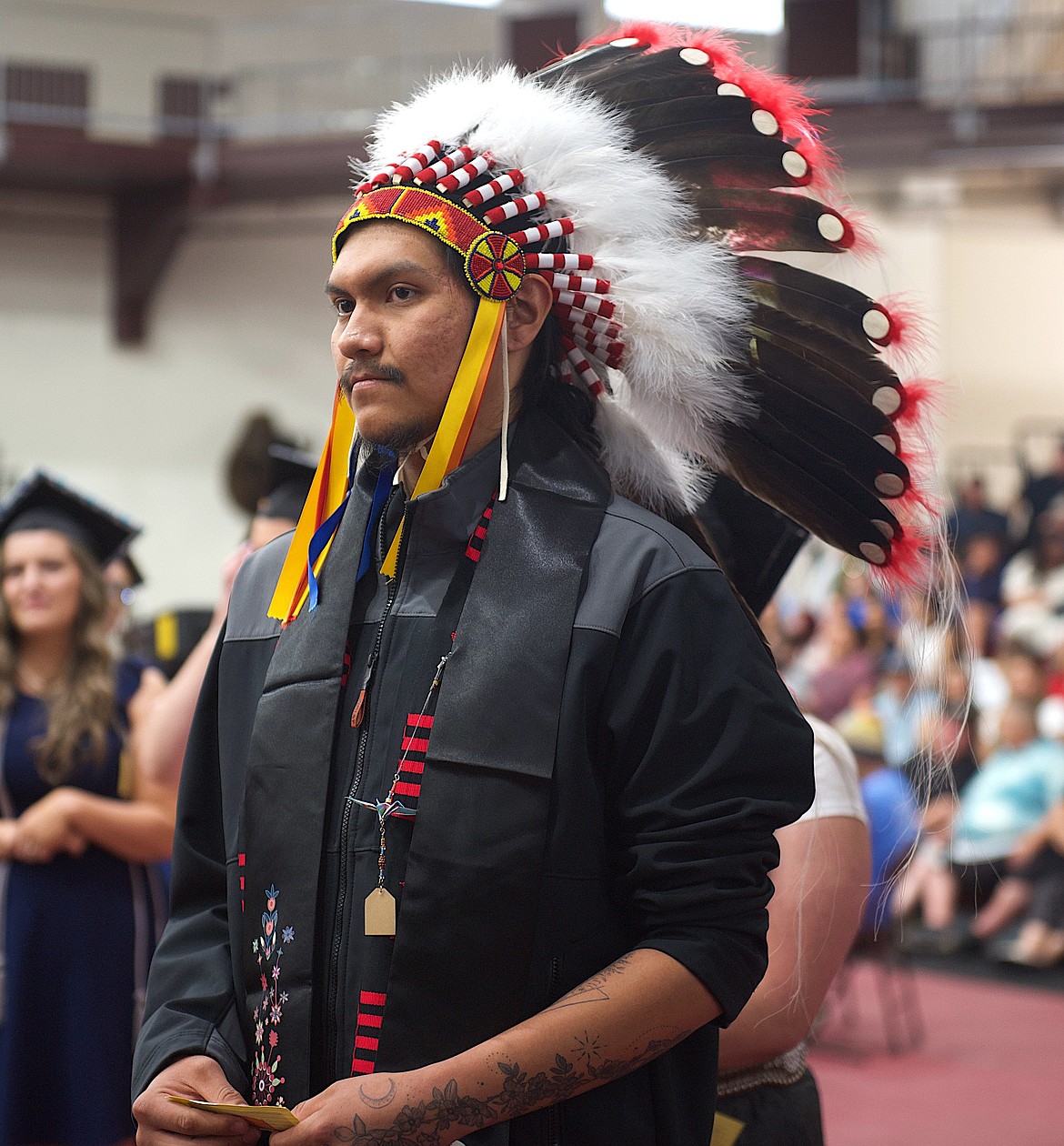 Graduate Kylin Medicine Bull was attired in a full headdress as he received his Associate of Arts in Psychology Saturday at Salish Kootenai College. (Kristi Niemeyer/Leader)