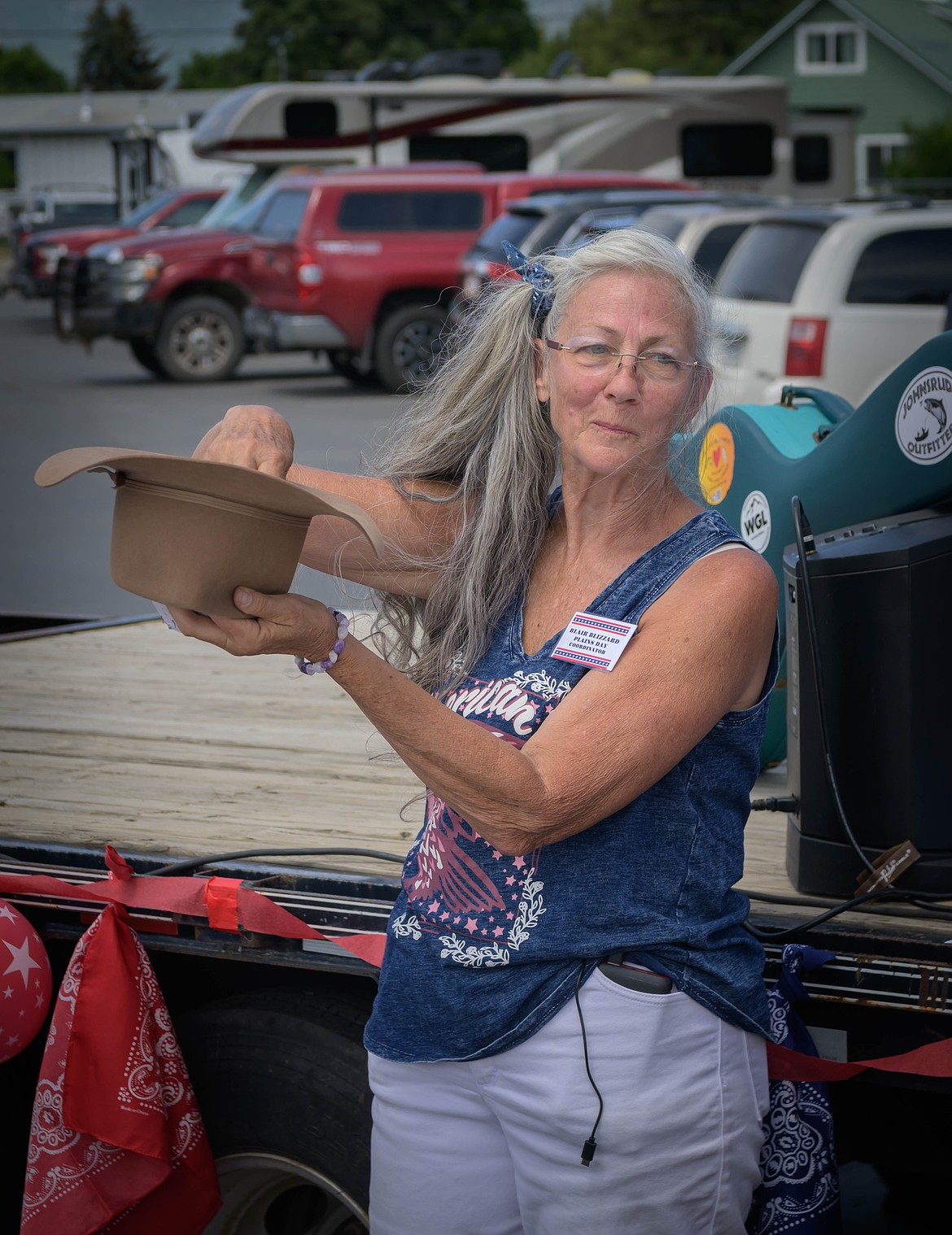 Blair Blizzard, one of the organizers of Plains Day, pulls names out of a hat for the pie eating 10 contest contestants. (Tracy Scott/Valley Press)