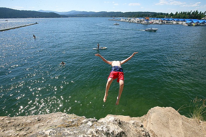 A youth leaps from Tubbs Hill, a popular outdoor leisure spot in Coeur d'Alene, in this file photo.