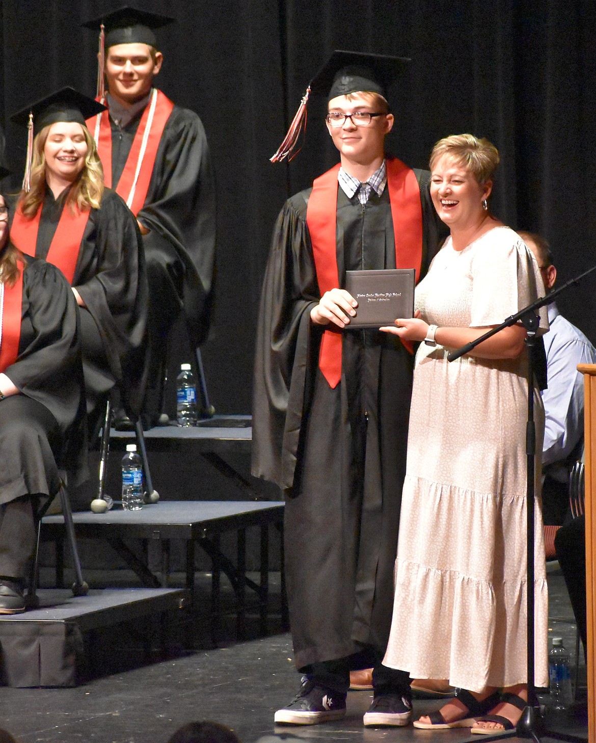 Zayden Melvin stands with Dawn Baergen as he is handed his diploma. Melvin said the feeling of graduating has been indescribable and plans to move to Arizona and pursue a career as a Cisco truck driver.