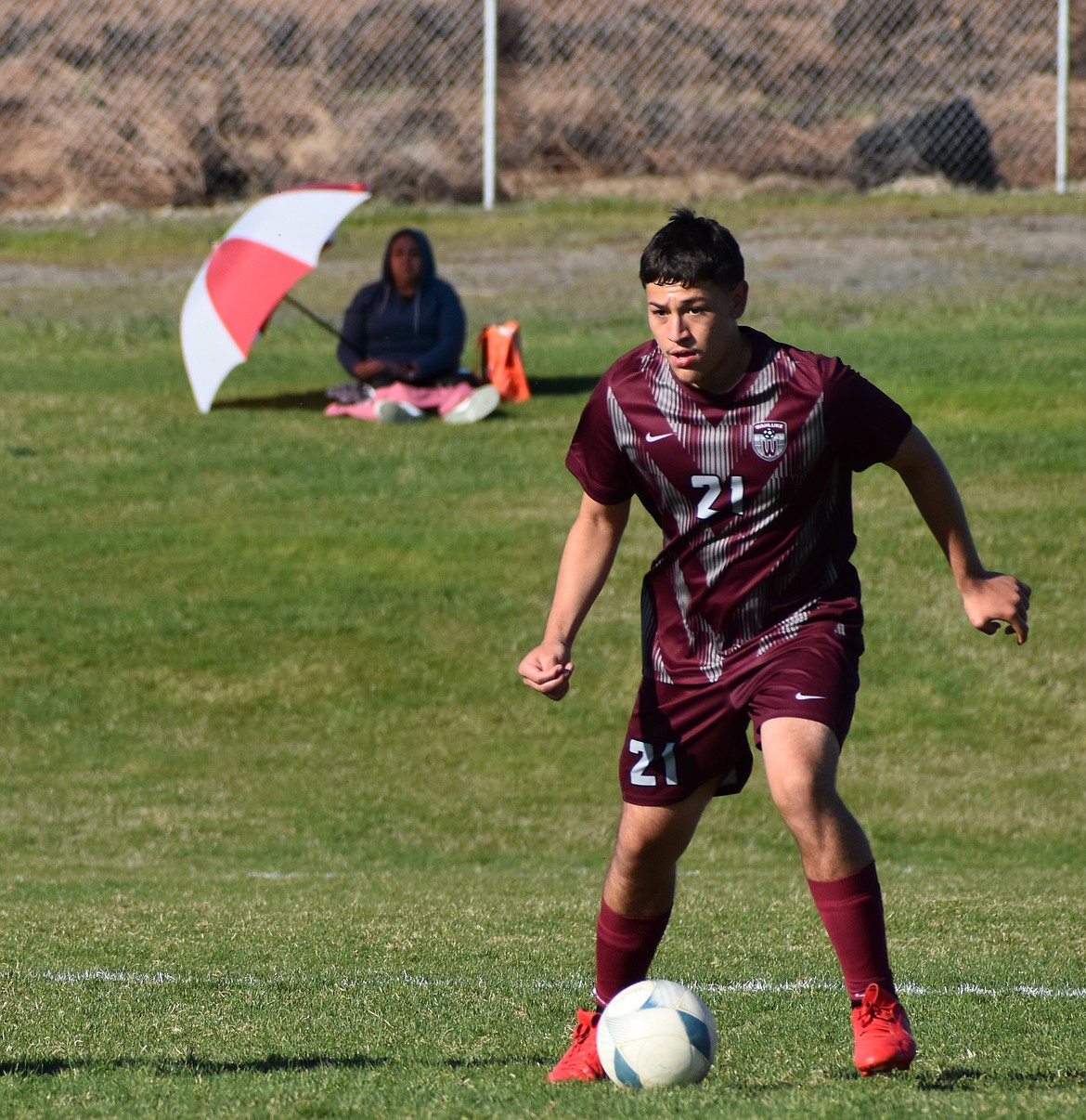 Franco Perez moves the ball down the field in a game in the middle of the season. Coach Cele Lopez said he is excited to see what the younger players on the team can accomplish next season.
