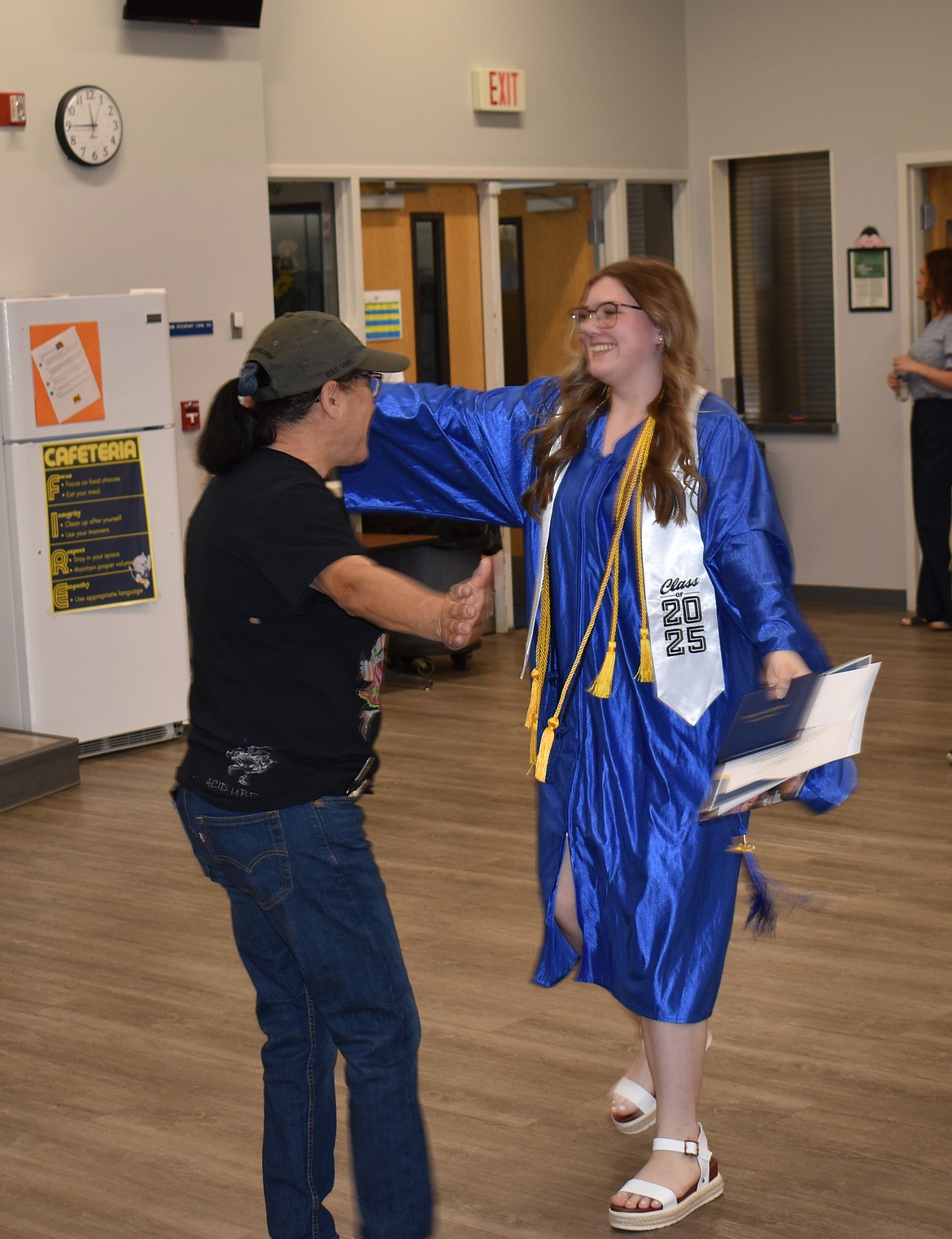 Neeley Odorizzi, right, goes in for a hug with custodian Sylvia Lee after Wilson Creek High School’s graduation ceremony May 31.