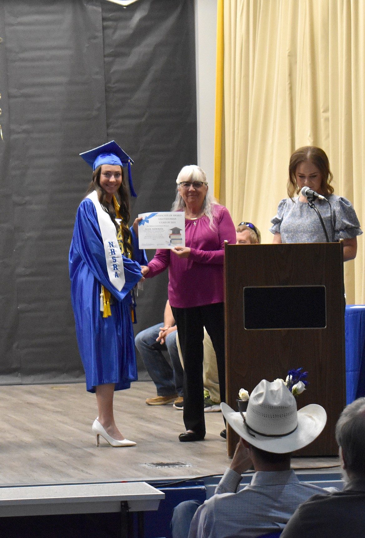 Wilson Creek High School Class of 2025 Salutatorian Allie Newman smiles as she gets a certificate from Superintendent Laura Christian at graduation May 31.