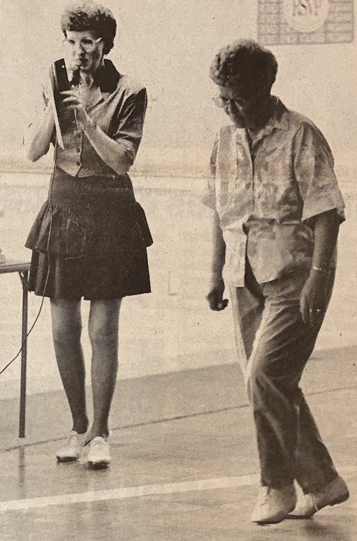 Instructor Judy Schenk, left, calls out clogging moves while Alma Coon dances in 1990.