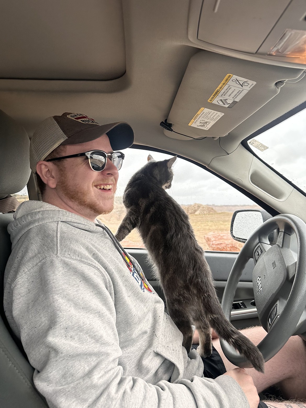 Mike Maynard and his cat Cletus on a car ride together. Maynard rescued Cletus in December, and he said that Cletus has become a key part of his life.