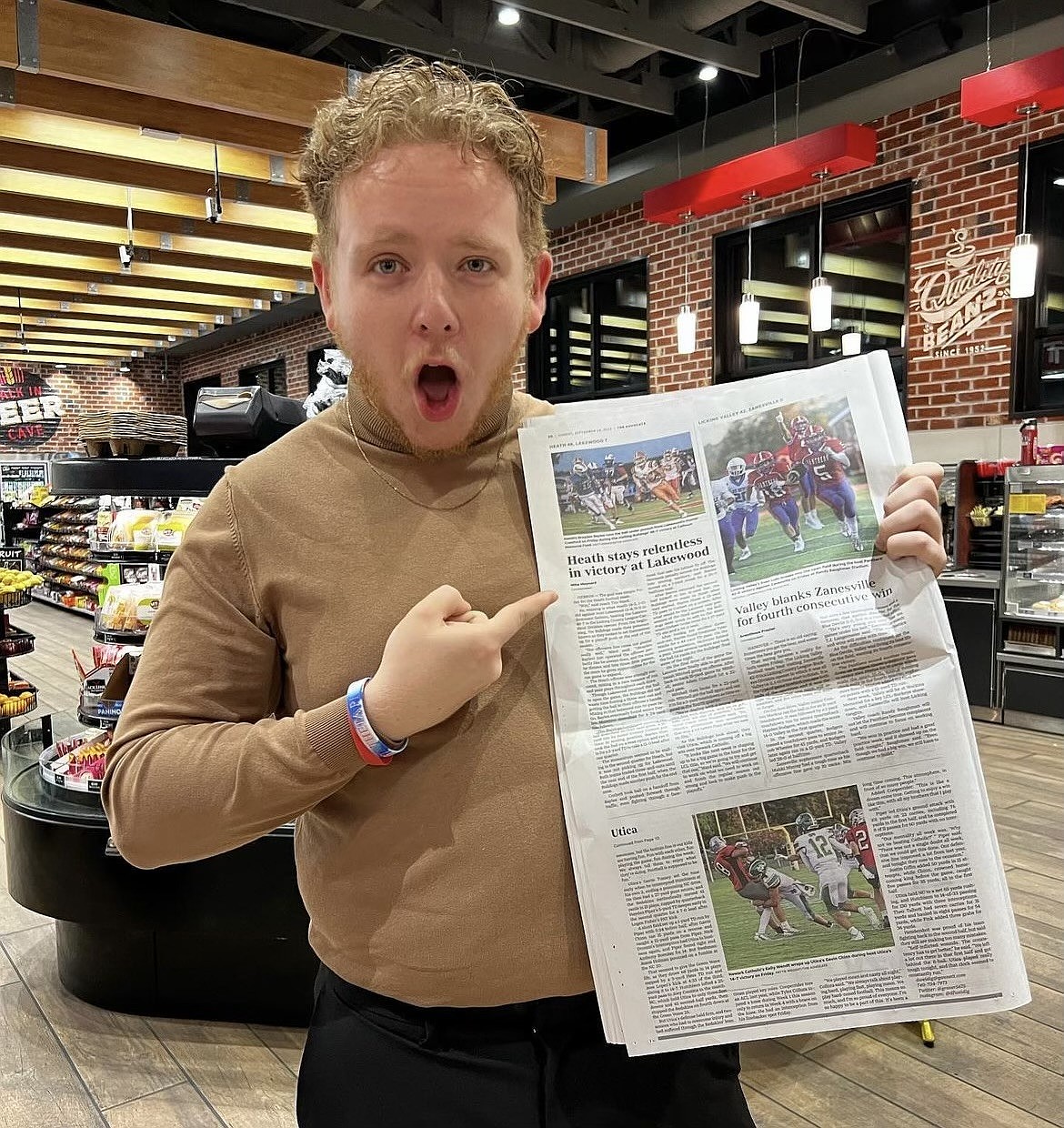 Mike Maynard holding a paper featuring one of his articles he wrote while attending college at Denison University. Mike Maynard graduated college in 2024 and made his way West as he pursued his career in journalism during the spring of this year. Maynard said he loves telling the stories of athletes.