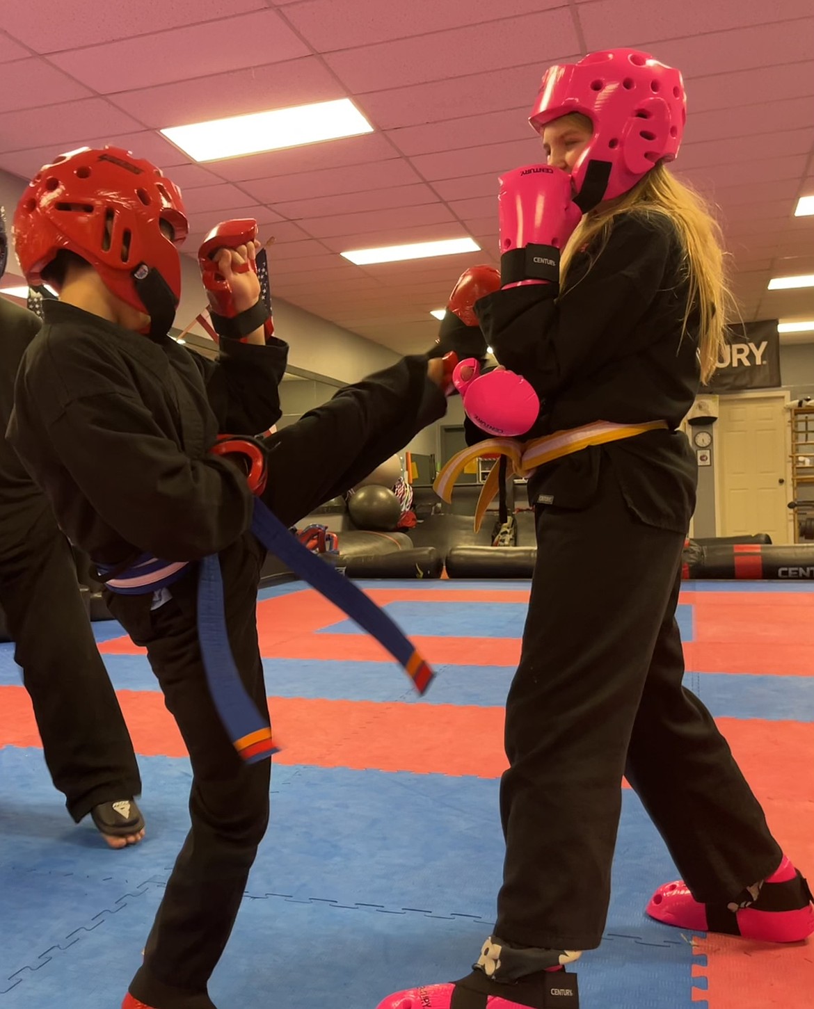Two students at Freewind Martial Arts work on kicks together. The Joni’s Angels scholarship will allow kids in poverty to have access to valuable lessons, according to Charlie Hicks, a Joni’s Angels ambassador and COO for the nonprofit.