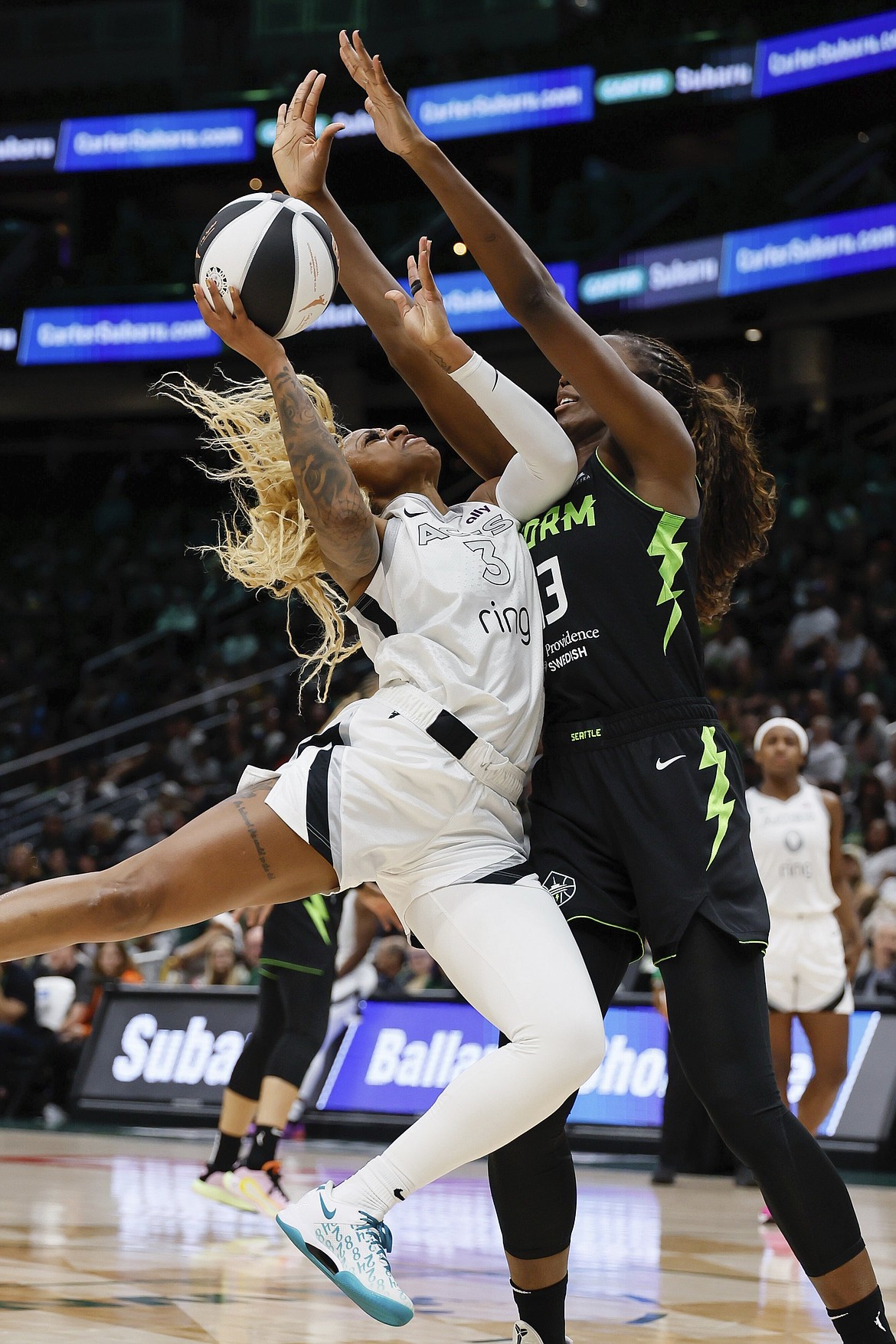 Las Vegas Aces guard Tiffany Mitchell , left, has her shot blocked by Seattle Storm forward Ezi Magbegor, right, during the second quarter of a WNBA basketball game Sunday, June 1, 2025, in Seattle.