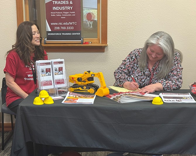 Colleen Hoffman, manager of North Idaho College Workforce Training’s Customized Training program (left), sits with Brenda Garver, the senior administrative assistant for Customized Training, at an information table during an
April event at the NIC Sandpoint Center, which is now operated by NIC Workforce Training. Businesses and organizations in counties throughout North Idaho can take advantage of the NIC Workforce Training’s Customized Training programs. (Courtesy of NIC Workforce Training)