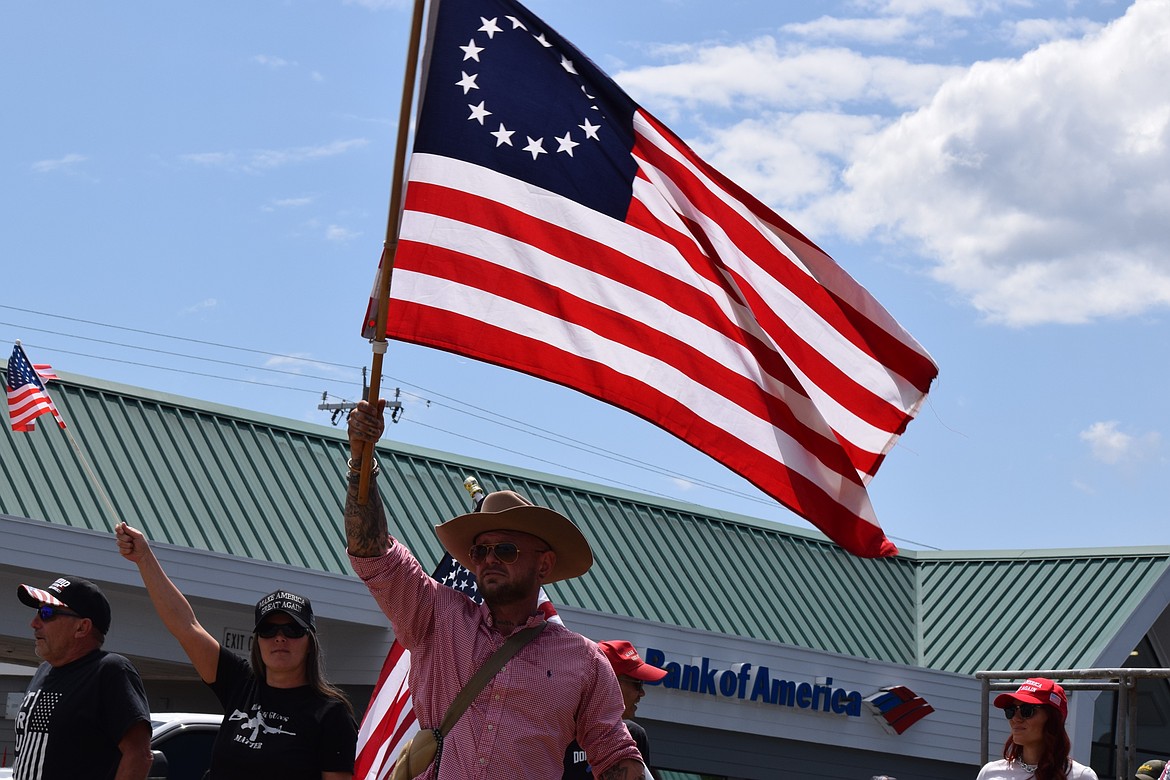 A man waves an American flag during a counter-protest in response to the "No Kings" demonstration along U.S. 95 in Coeur d'Alene on Saturday.