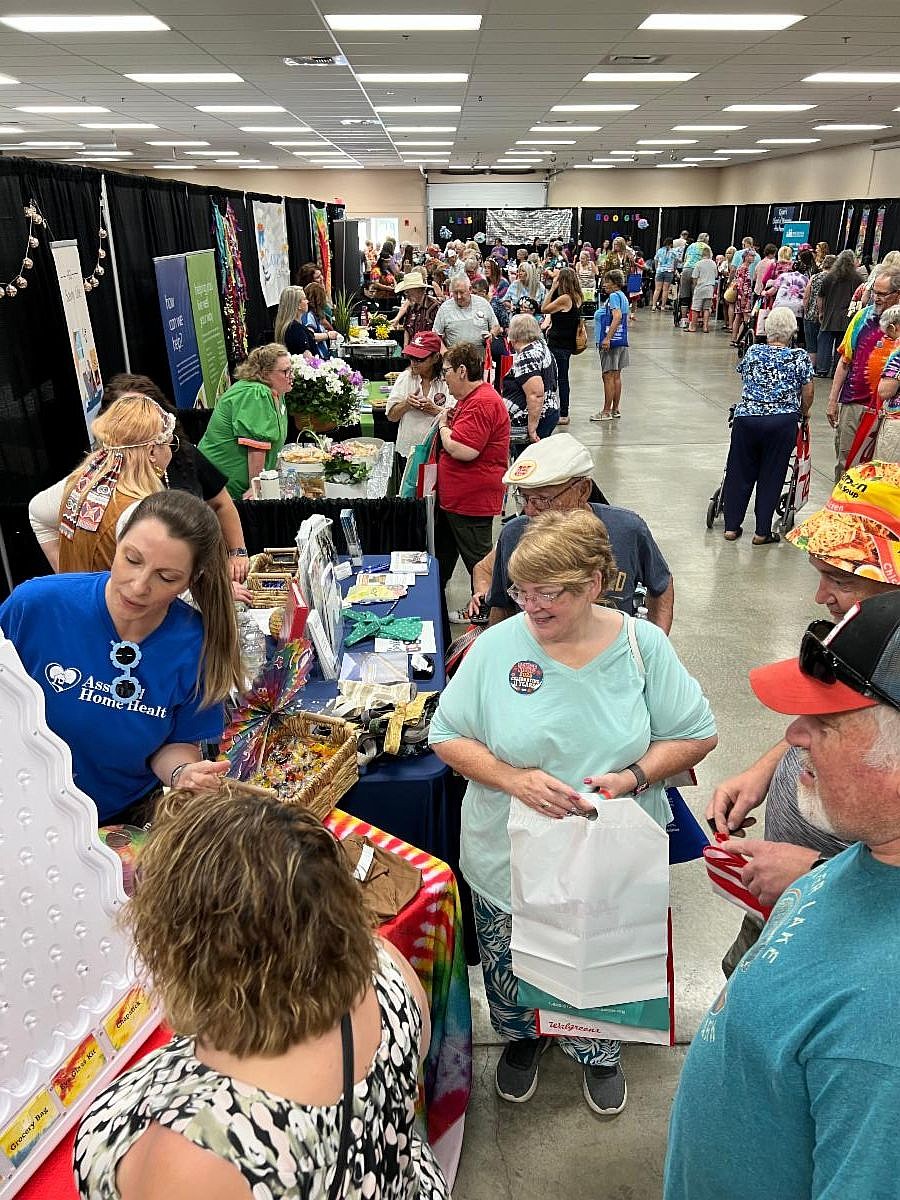 Attendees at the Moses Lake Chamber of Commerce’s Senior Picnic visit information booths.