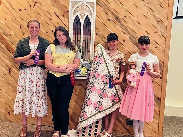 From left, Katherine Wrobleski, Hannah Olson, Ailie Avilla, Anaelle Avilla at the Sanders County 4-H Fashion Revue. Judging is based on presentation of the ensemble (fit, grooming, poise and accessories), construction and an interview. In the Sewing & Textiles category, Anaelle Avilla placed first, Ailie Avilla earned a blue ribbon and Hannah Olson a red ribbon. In quilting, Ailie Avilla placed first, and in knitting Katherine Wrobleski placed first. (Photo provided)