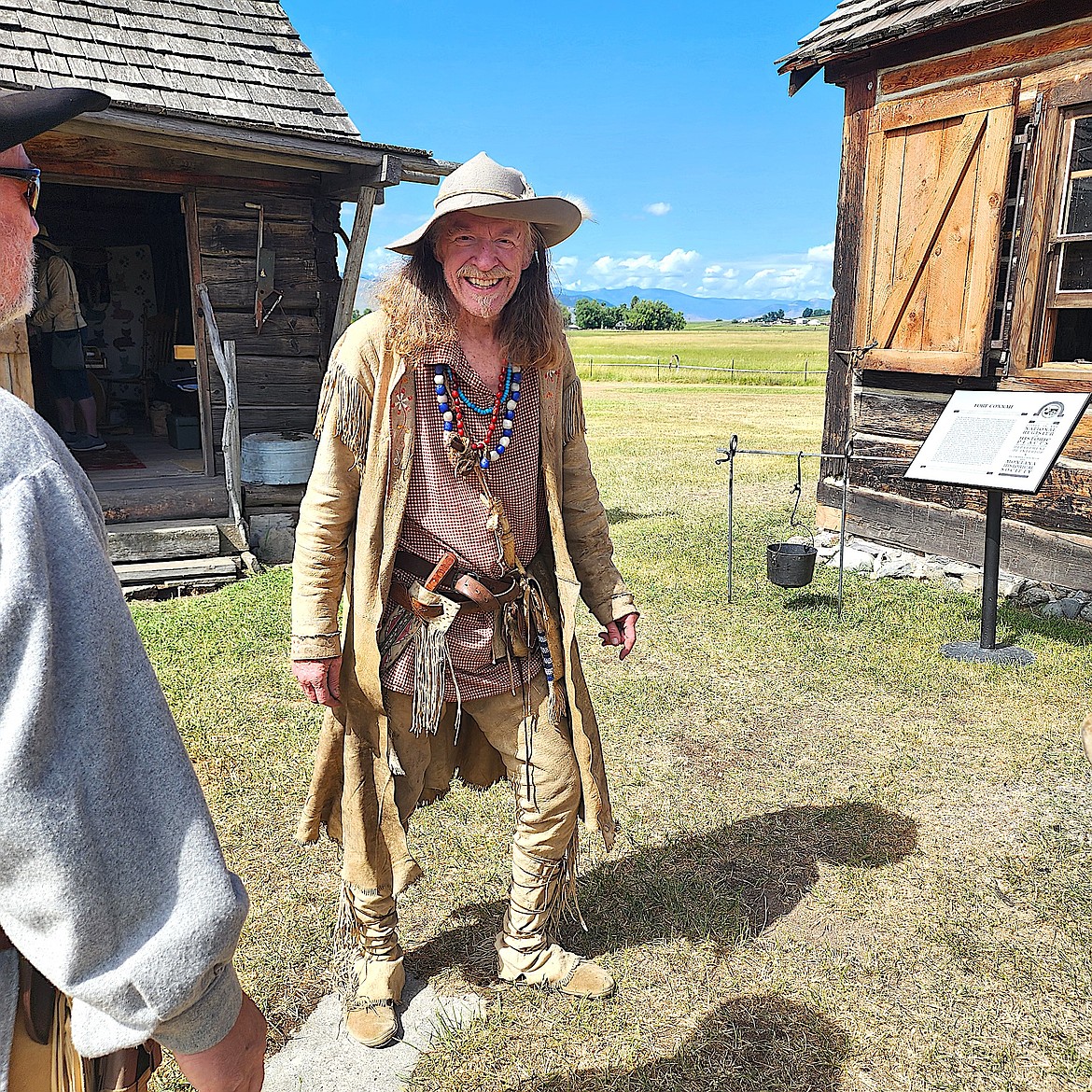 Gunsmith Mark Willoughby talks about making his mountain man clothing at Fort Connah's event last weekend. (Berl Tiskus/Leader)