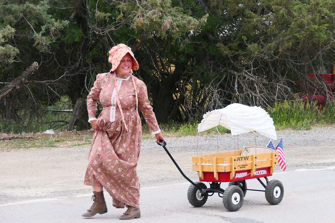 A Hot Springs "pioneer" pulls a "covered wagon" in the spirit of the Homesteader Days during the annual parade this past Sunday in Hot Springs.  (Chuck Bandel/VP-MI)