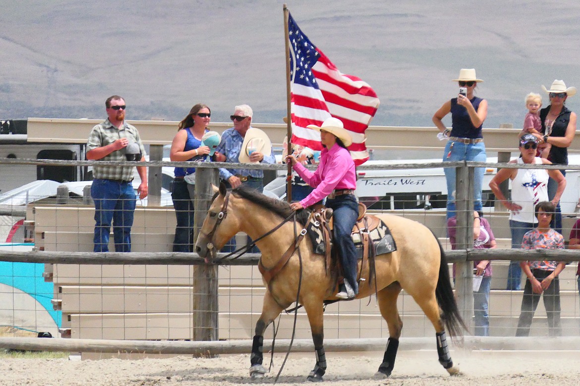 Old Glory is ridden around the arena at the start of the Homesteader Days rodeo this past Sunday in Hot Springs.  (Chuck Bandel/VP-MI)