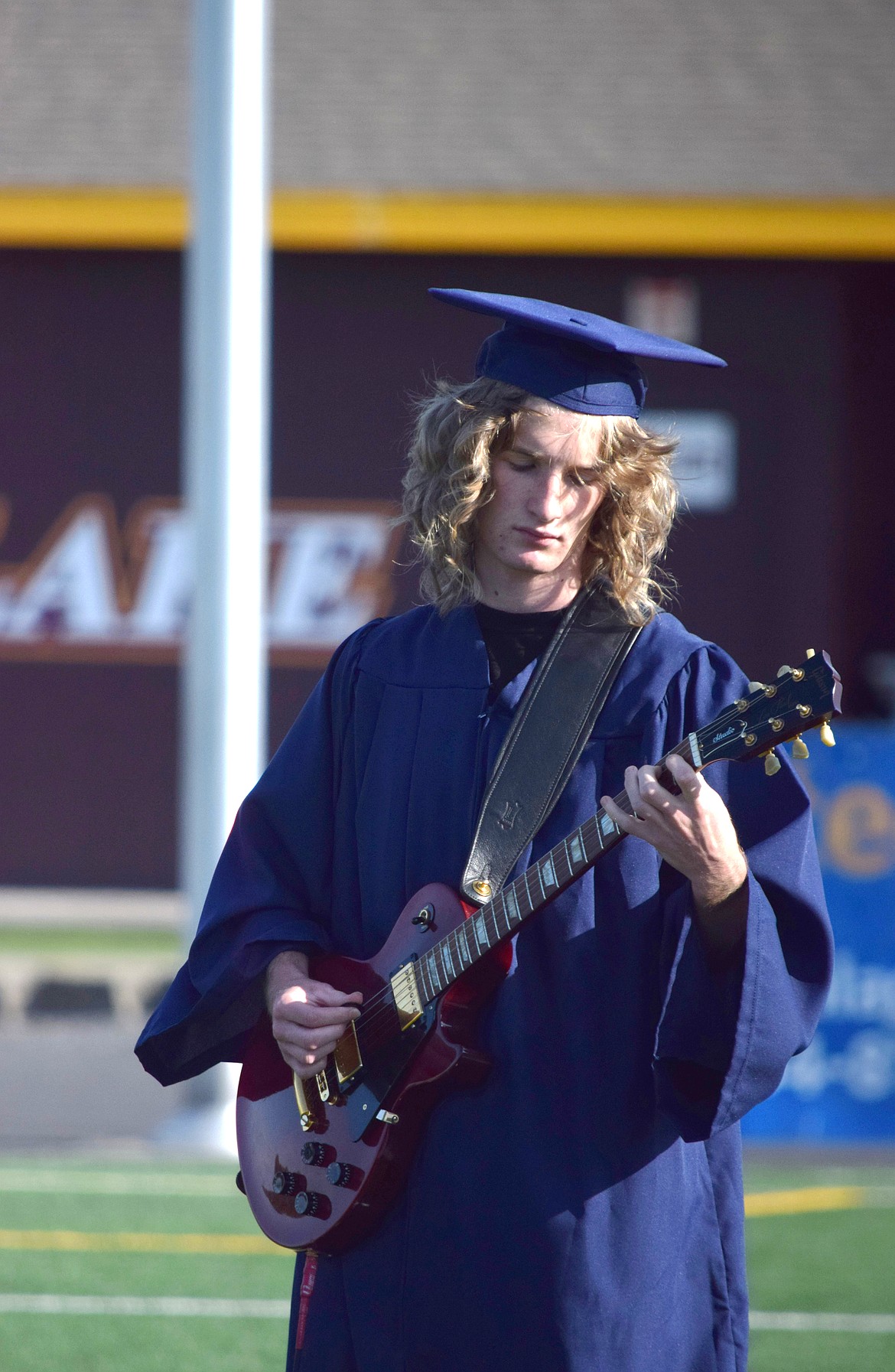 Elijah Legault plays the national anthem on the guitar at Big Bend Community College graduation Friday.