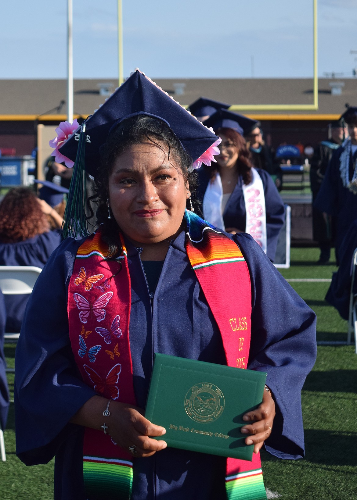 A Big Bend Community College graduate walks back to her seat with her diploma.