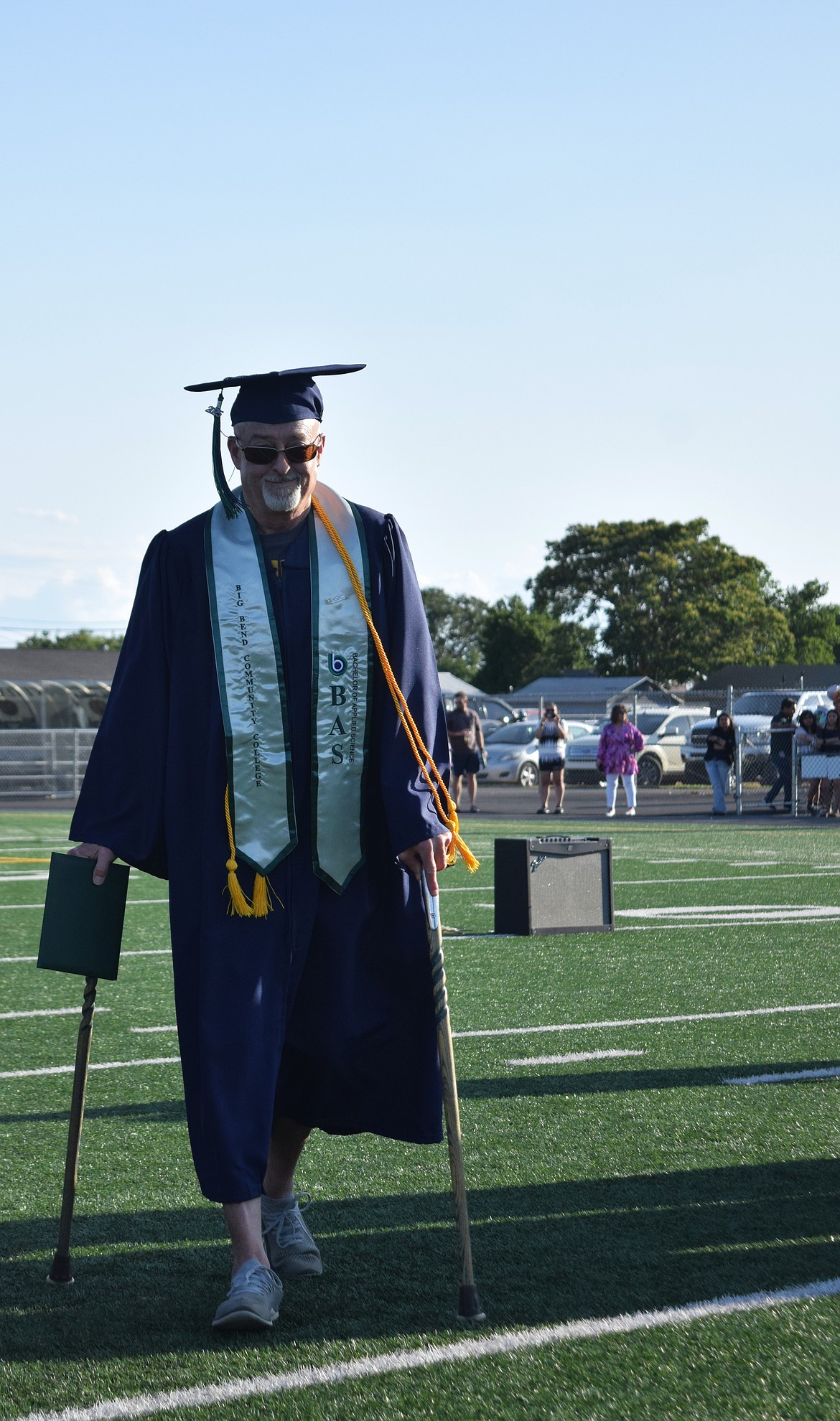 A Big Bend Community College graduate walks back to his seat, diploma in hand, Friday during graduation.