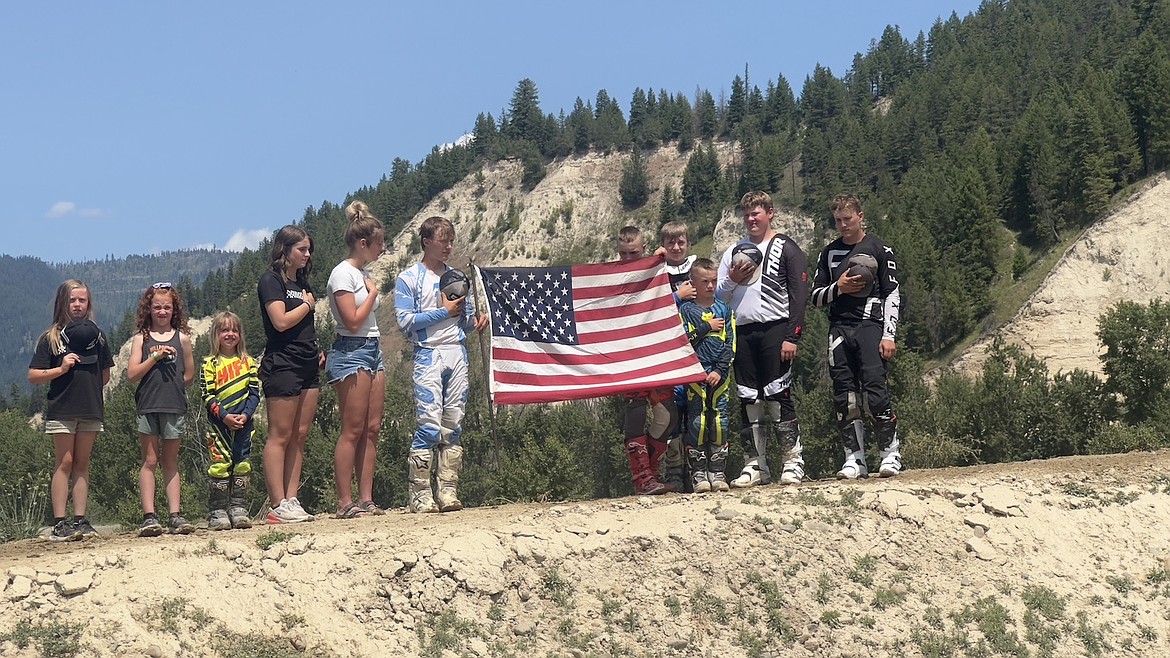 Millpond Motocross racers display the U.S. flag during opening ceremonies Sunday, June 15, 2025. (Courtesy photo)