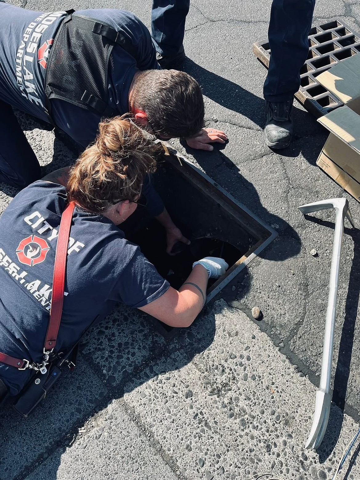 Two Moses Lake Fire Department first responders worked to rescue ducks out of a storm drain outside of Safeway in the afternoon. This was the second rescue of the day for the ducklings.