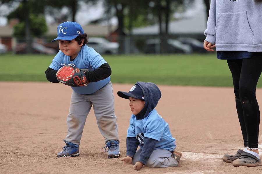 Two little league baseball players stand ready at first base. Little league baseball is one of many summer sports happening this year. They will have flag football, soccer and an adult co-ed softball league.