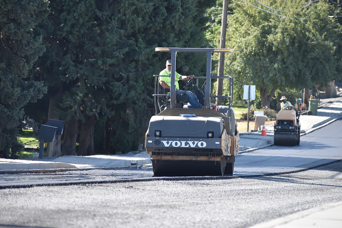 Rollers compact newly laid asphalt on Westshore Drive west of Moses Lake.