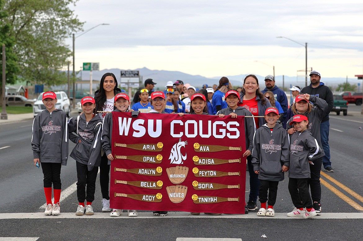 The Cougs pose for their photo during the Opening Day parade. According to Parks and Recreation Coordinator Valerie Hernandez, around 300 kids tried out for the little league teams this year.