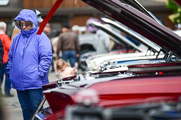 An attendee dresses for the wind and rain forecasted during the 10th The Big Shindig in Kalispell on Saturday, June 21. The Big Shindig features a wide range of classic and custom vehicles as well as live music, food, drinks and contests like the pin-up polar plunge. Hosted by the Glacier Street Rod Association and the Desoto Grill, money raised benefits Mikayla’s Miracles and Blessings Foundation. (Casey Kreider/Daily Inter Lake)