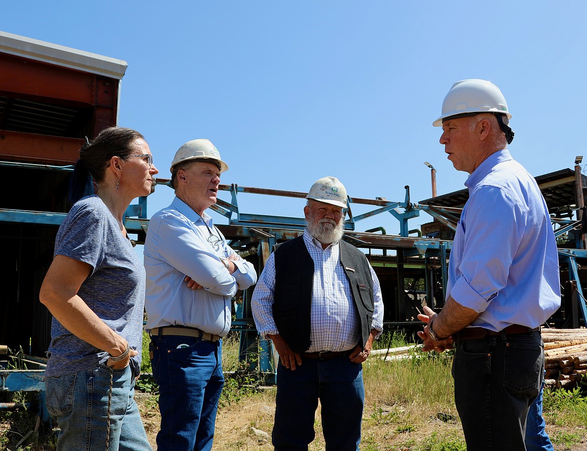 Liz Thompson with Big Sky Forest Products, Rep. Curtis Cochran, Sen. Denley Loge and Gov. Greg Gianforte talk in the yard of Big Sky Forest Products in St. Regis last week when the governor was on his annual 56 County Tour. (Courtesy photo)