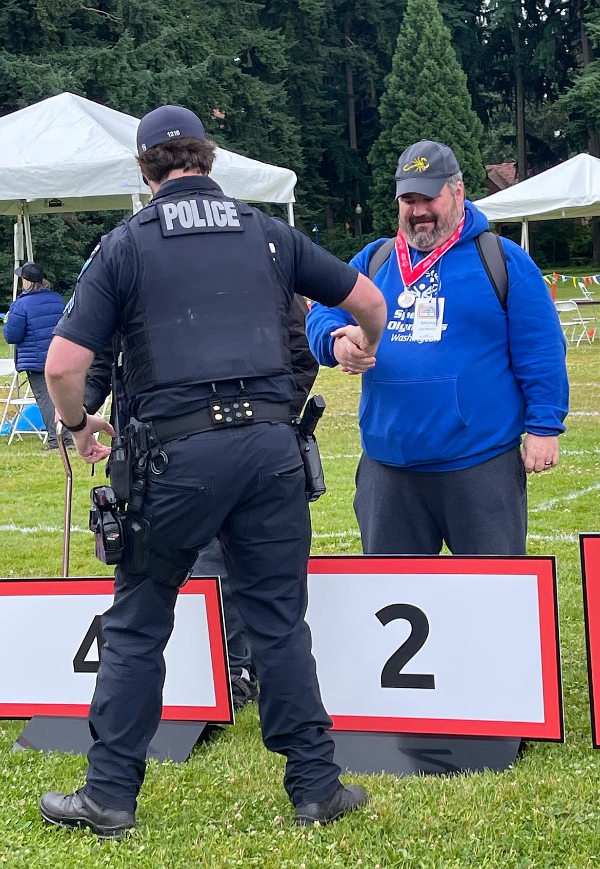 Cory Dempsey shakes the hand of an officer after receiving his medal for second place in the bocce tournament. Coach Shane Lunderville said he was impressed by how the team performed without his input in the championships.