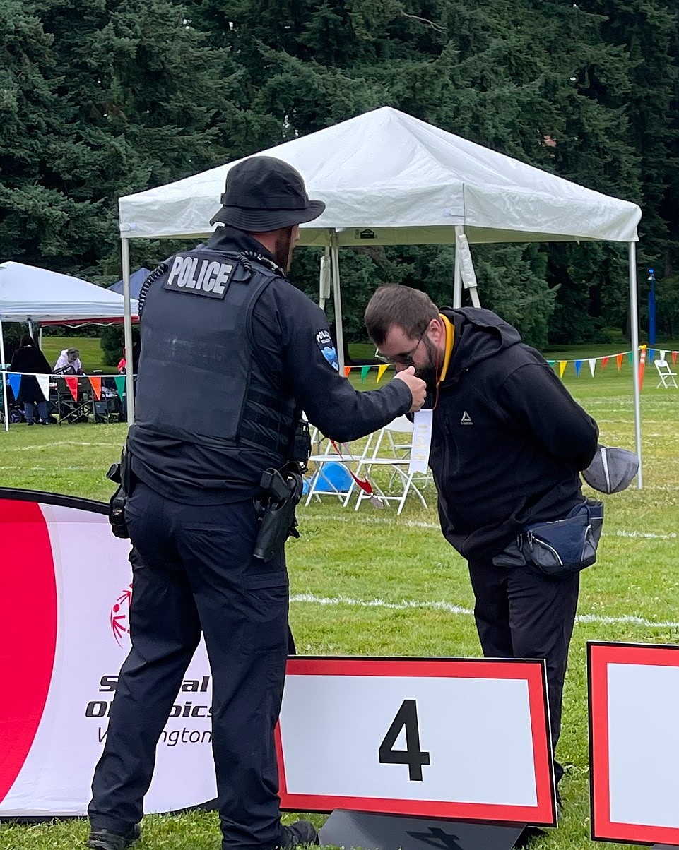 Earning fourth at the bocce state tournament, Isaac Lunderville receives his award from an officer. Coach Shane Lunderville said he expects the team roster to grow by next season.