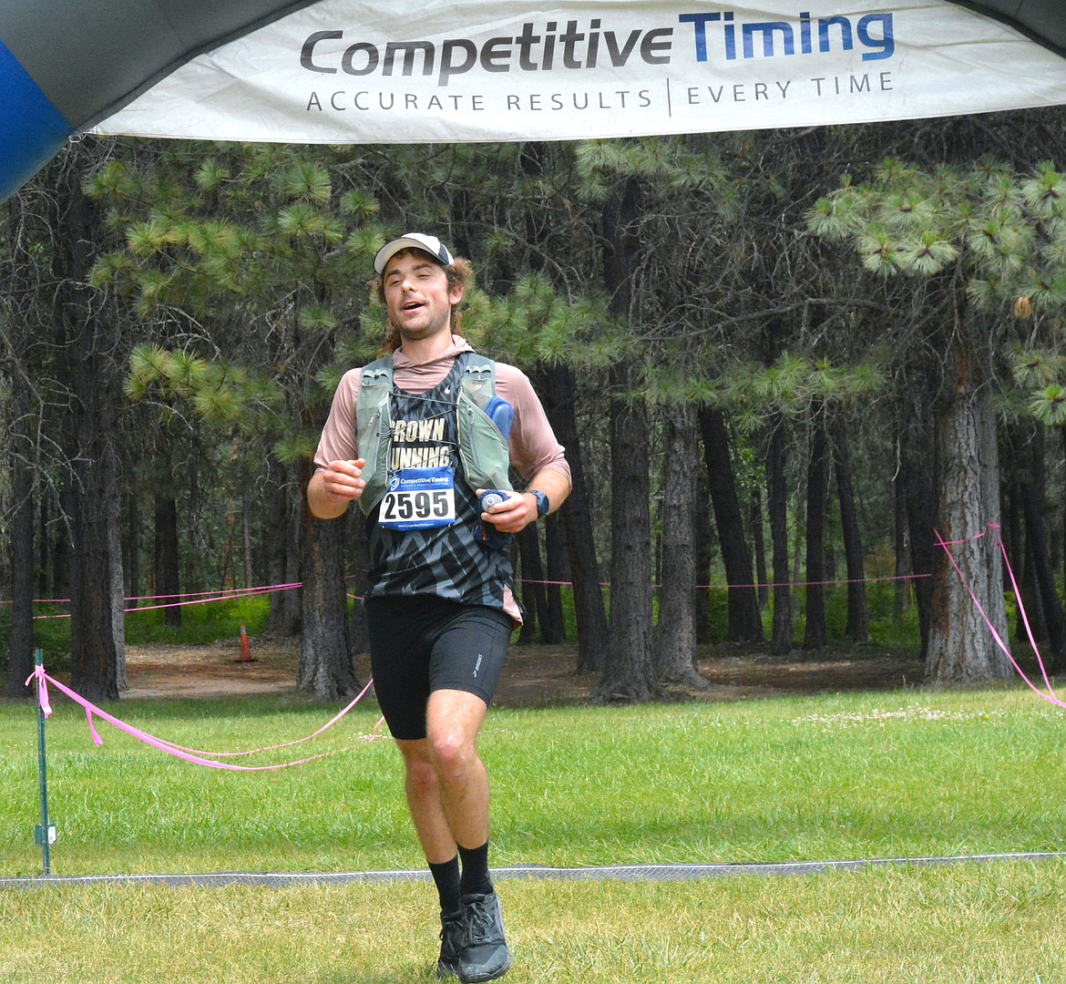 Preston Kauder of Moscow, Idaho, ran into the St. Regis Community Park on Saturday during the 2025 Trail Rail Run, completing his first-ever 50-mile ultra marathon. After crossing the finish line, he swiftly sat down on the grass to rest his weary legs. (Mineral Independent/Amy Quinlivan)