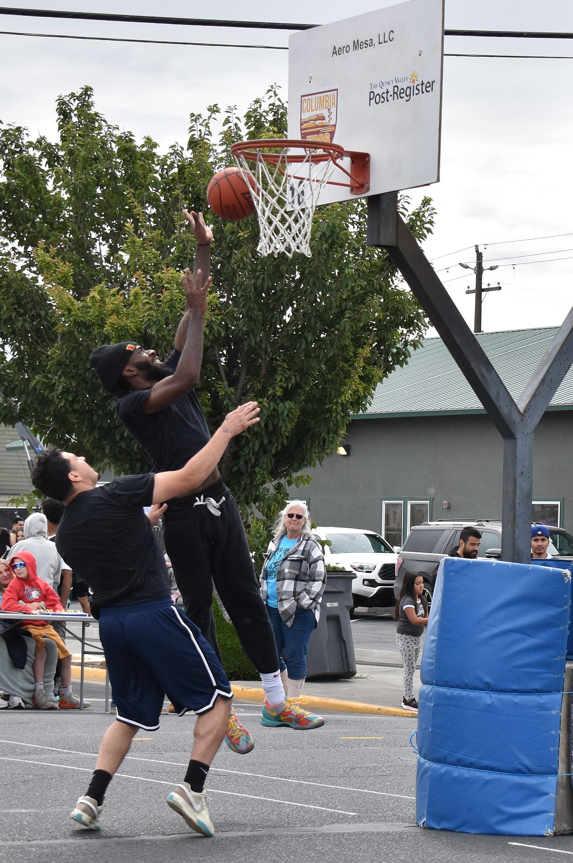A player in one of the adult brackets makes a layup at the hoop while being defended against. The adult brackets consisted of a Rec, Elite, and Mature division.