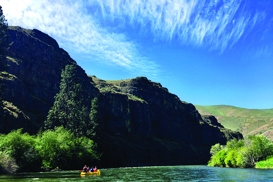 A photo of people rafting on the Yakima River. Canyon River Ranch offers guided tours down the river where people can learn the history of the area and see local wildlife.