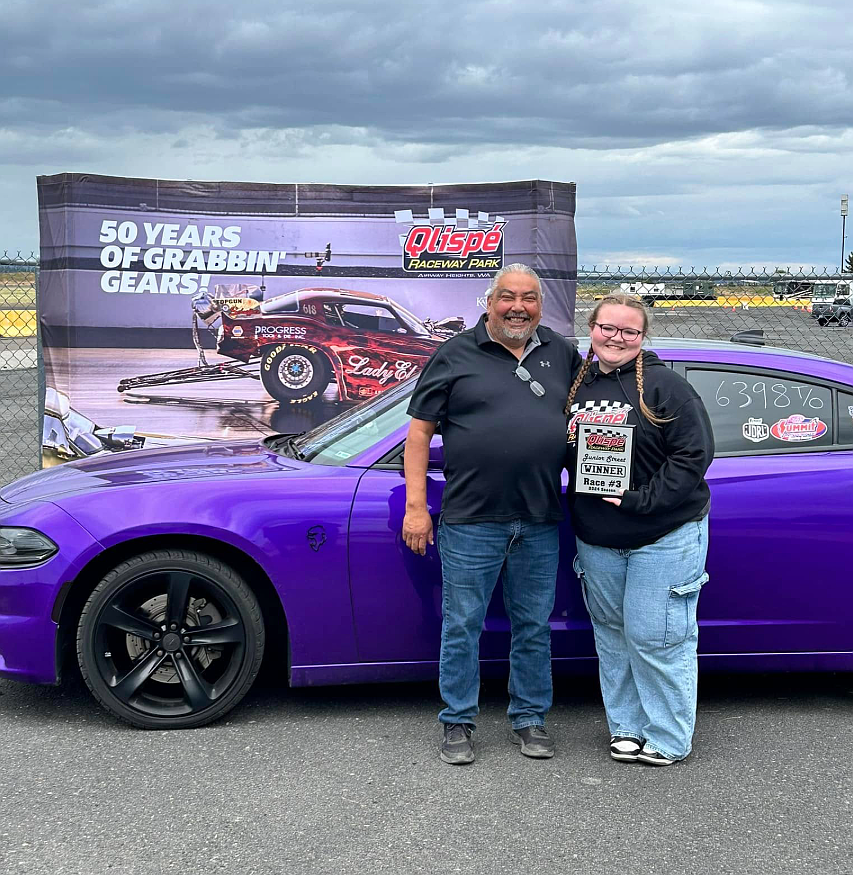 Hydee Lyman is seen with track operator RJ Nomee June 2, 2024 at Qlispé Raceway Park in Airway Heights. Hydee, holding an award, is a top racer in the Junior Street program.