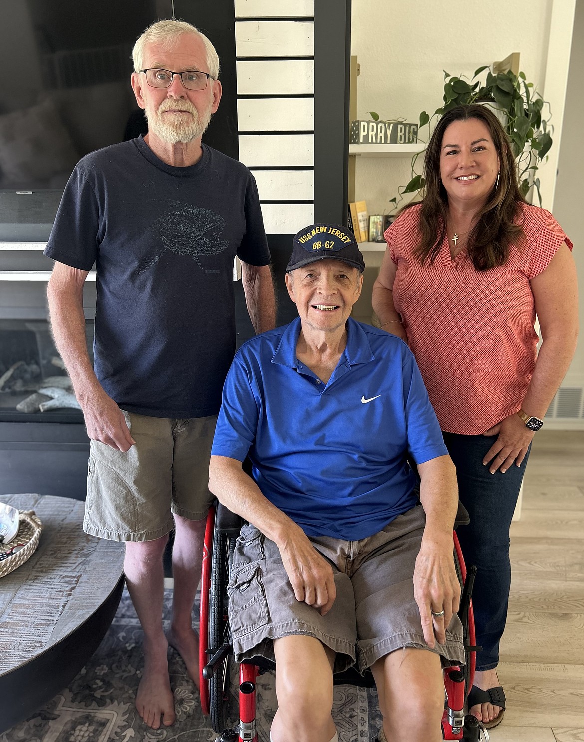 Melissa Hostetler joins Stephen Cramer, left, and Frank Conrad for a picture in her Coeur d'Alene medical foster home for veterans.