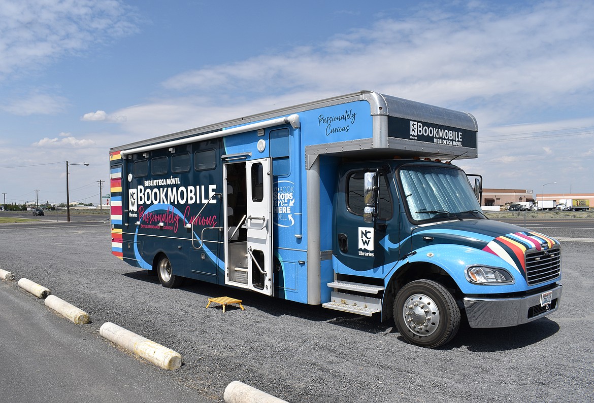 The NCW Libraries Bookmobile awaits patrons in the parking lot at Doolittle Dream Park in the Larson Community of Moses Lake. It stops there for an hour twice a month, one of about 15 stops the rolling library makes every week.