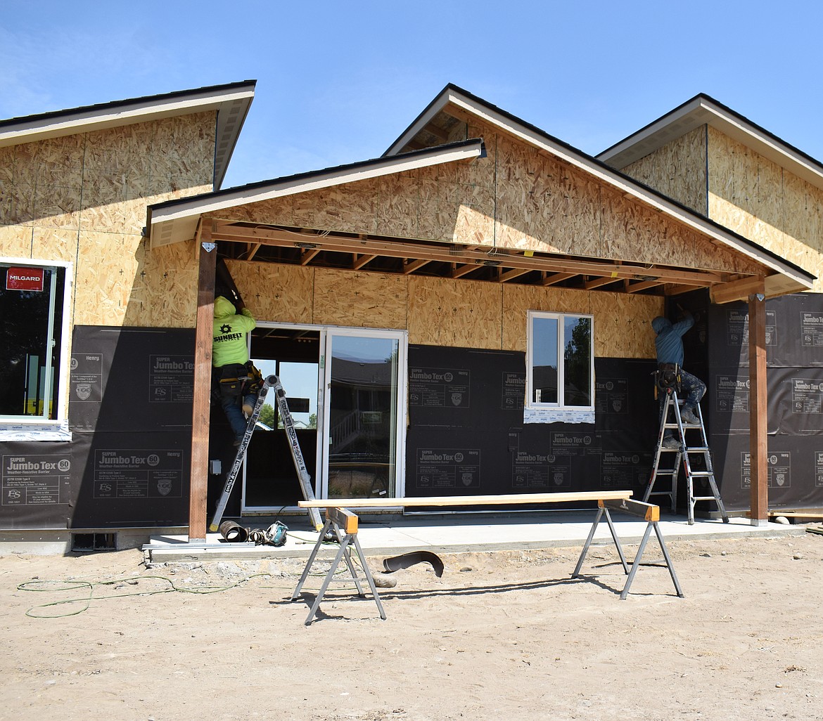 A crew works on a Sage Point home in the new development on the lower peninsula of Moses Lake.