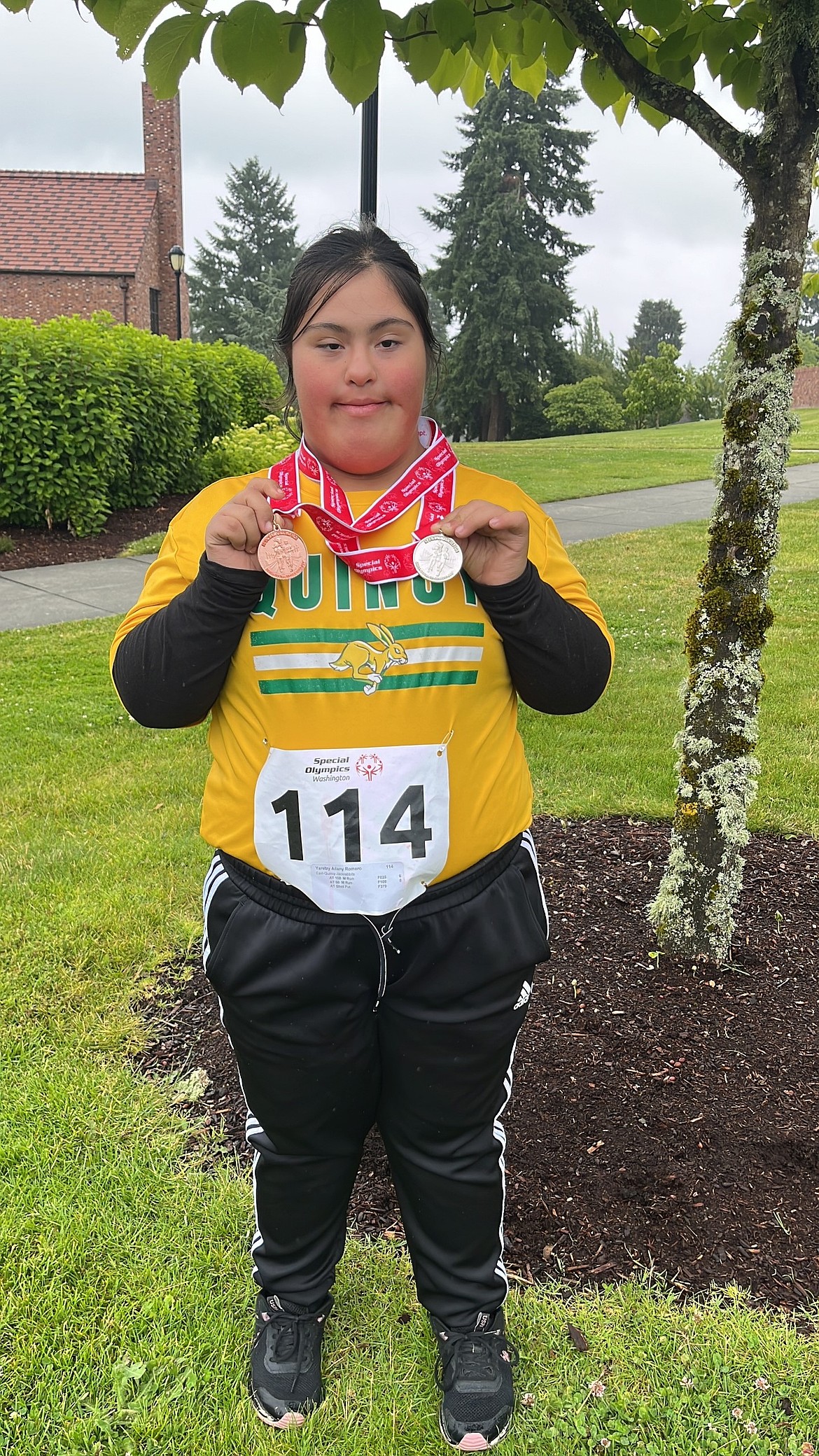 Quincy’s Yaretzy Romero holds up the medals that she earned in the tournament. She earned silver in the 50m dash, bronze in the 100m dash and silver in shotput.