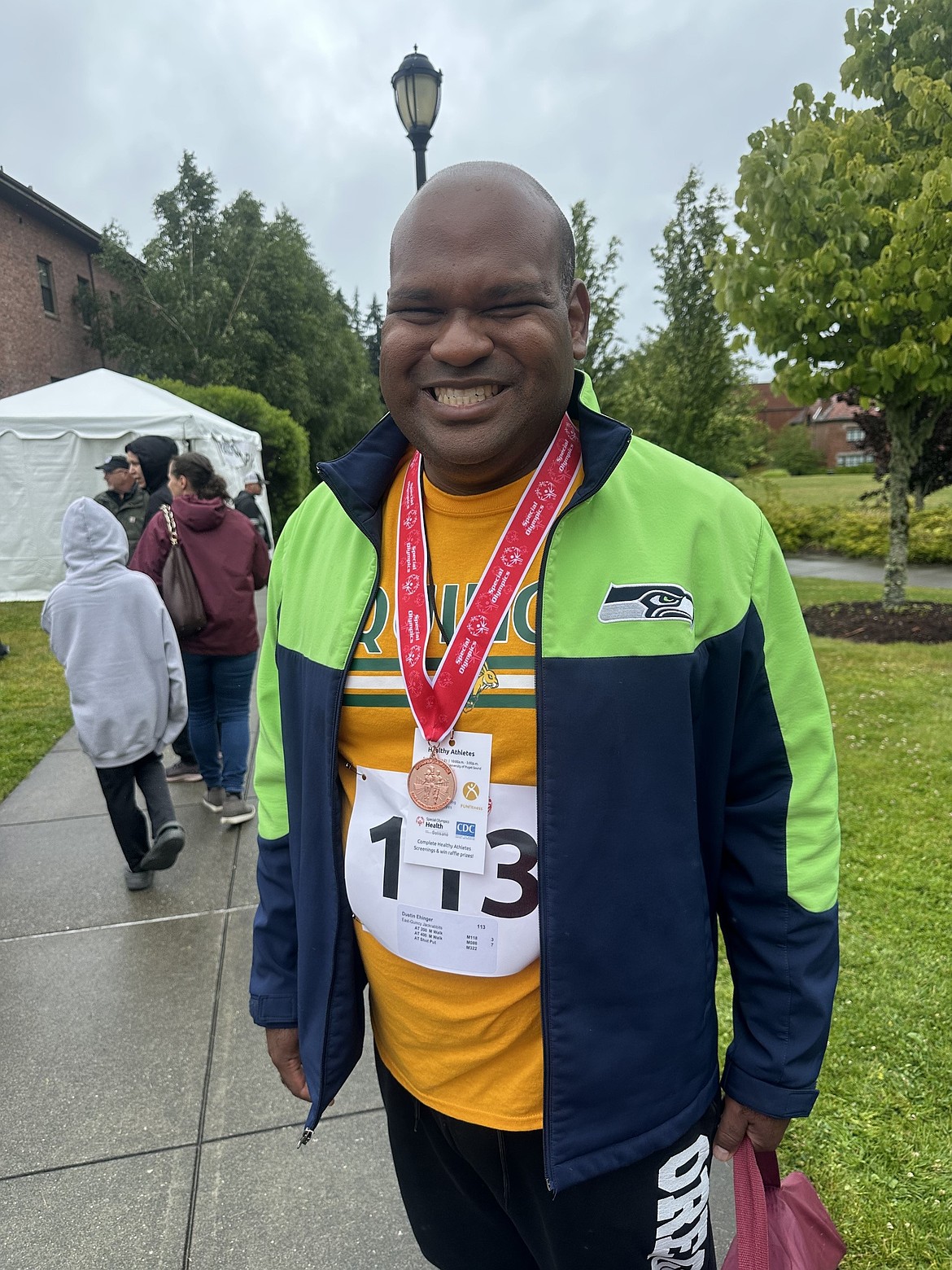 Quincy Jacks’ Dustin Ehinger stands with his bronze medal earned in shotput. Ehinger also earned a silver for the 400m walk and finished fourth in the 200m walk.