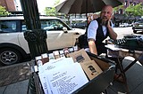 Traveling poet creating on-the-spot works outside Art Spirit Gallery