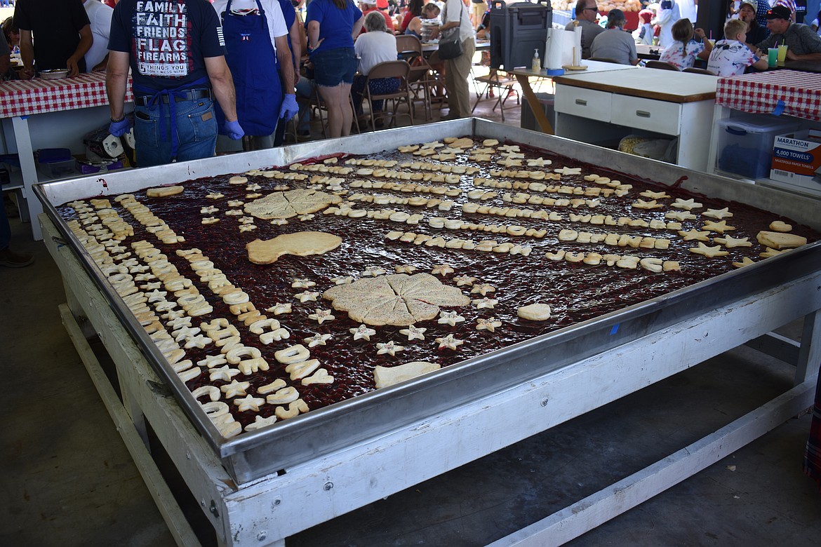The enormous cherry pie is the centerpiece of George’s Independence Day festivities.