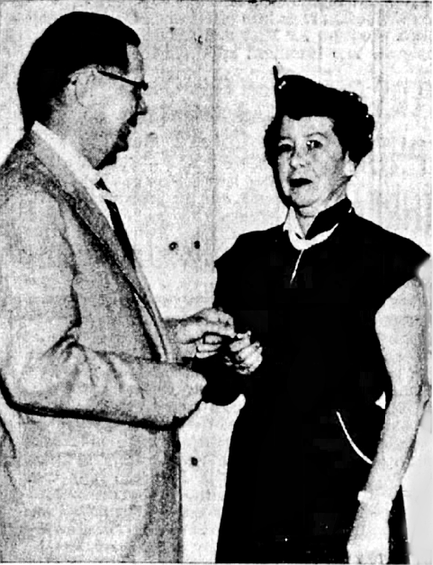 Coeur d’Alene Mayor Perry Christianson presents the Supervisor’s Wings to Leona Sotin at a special awards ceremony honoring the achievement of GOC volunteers. Mrs. Sotin also received a certificate signifying that she had reached the 500-hour plateau serving skywatch duty. Before leaving the program in 1958, she had accumulated a total of 1,750 hours.