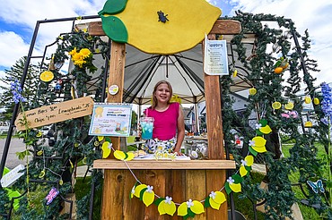 Sophia Derozier serves a cup of Blue Fairy Raspberry Lemonade at her Sour Fairy Sips stand for Lemonade Day on Saturday, June 28. (Casey Kreider/Daily Inter Lake)