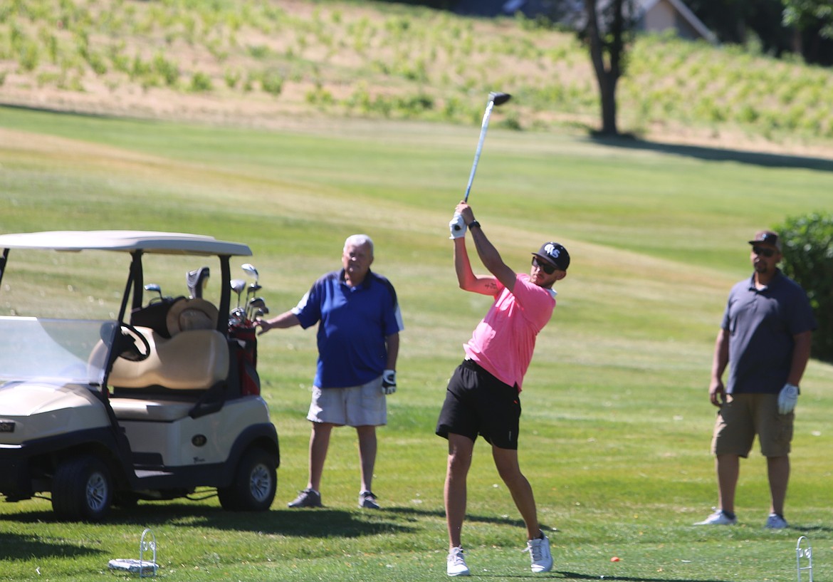 A golfer tees off at the start of a hole at the Sage Hills Golf Course. Warden wrestling alumni gathered to raise money for the wrestling program.