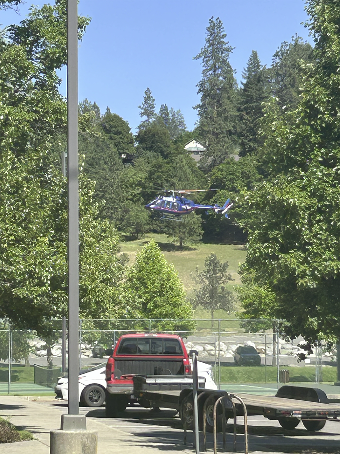 BILL BULEY/Press
A helicopter lands at Cherry Hill Park on Sunday afternoon, following reports of an ambush attack on firefighters called to a brush fire on Canfield Mountain.