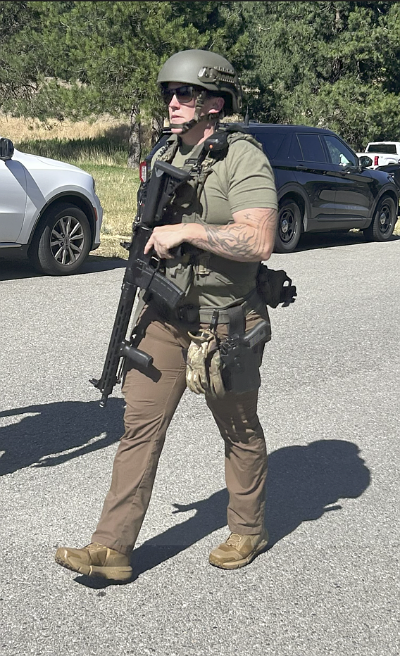 BILL BULEY/Press
A law enforcement officer at Cherry Hill Park in Coeur d'Alene, near the scene of an ambush attack on firefighters responding to a brush fire Sunday afternoon on Canfield Mountain.