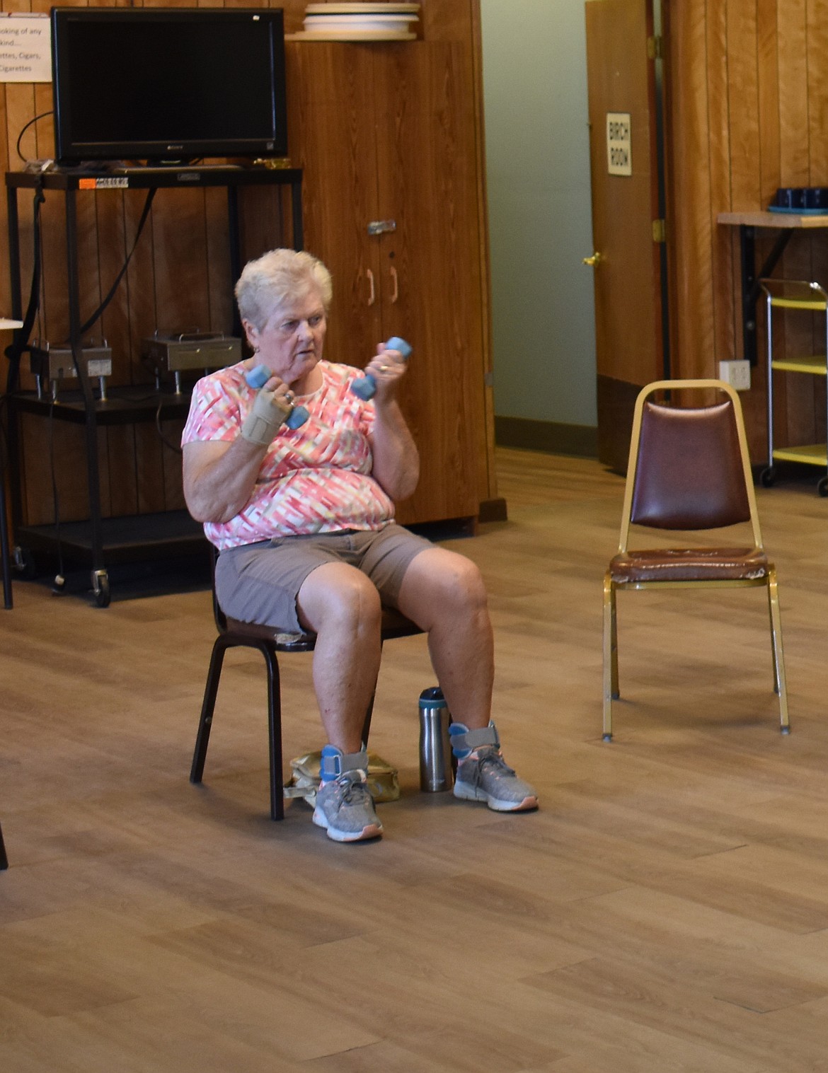 Karen Singer works out with hand weights at the Moses Lake Senior Center’s SAIL class Monday.
