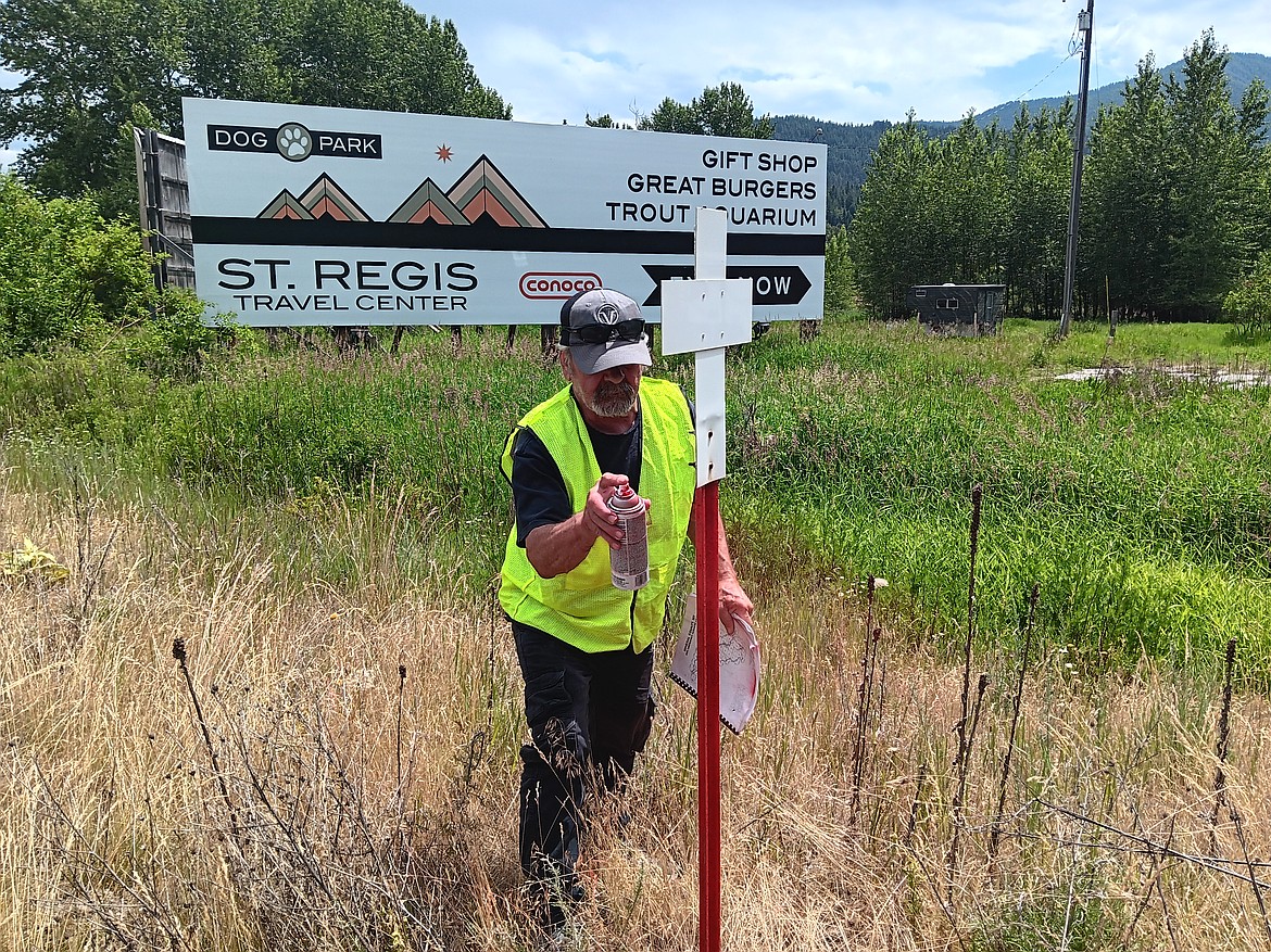 Ray Welch American Legion Post 13 Commander, Vince Triplett touches up a Fatality Marker on I-90 recently. A single white cross indicates a life lost in a vehicle accident. 2-white crosses are for 2 losses in the same accident. Mineral County has had over 300 highway fatalities since the program was initiated in 1953.