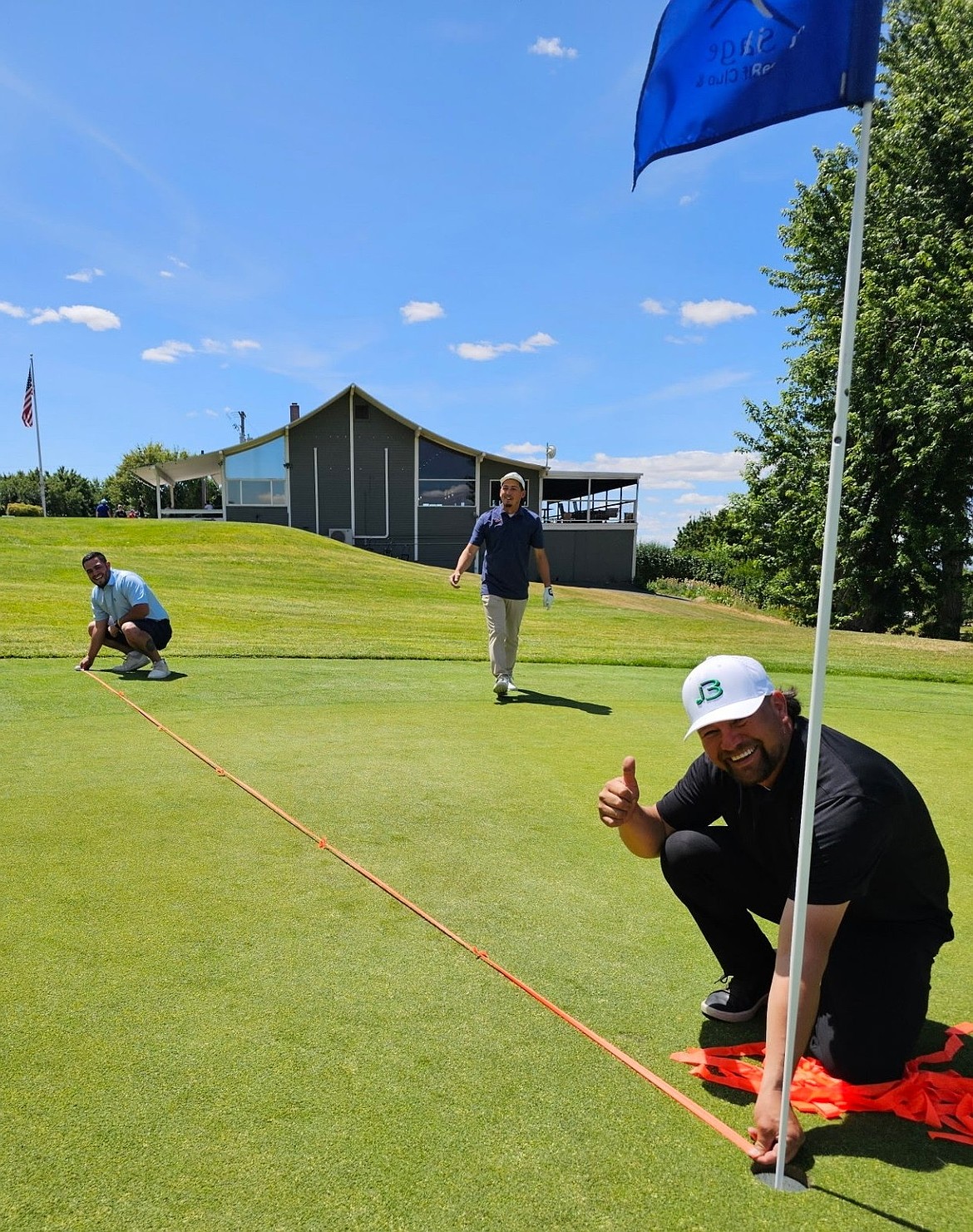 Three Bros team captain Camillo Mendez gives a thumbs up during the golf fundraiser. Mendez and his team came from Othello to support the Warden wrestling program.